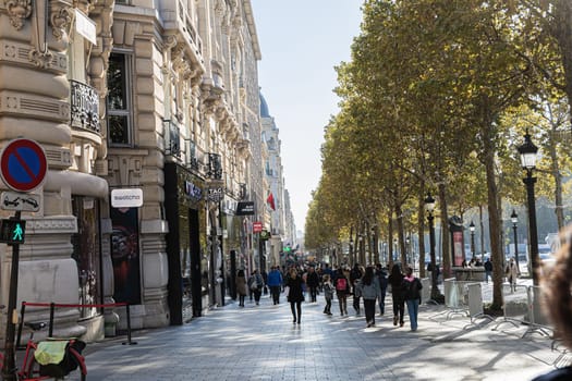 Central street of Paris The Avenue des Champs-Elysees with luxury shops and street life. Paris, France - November 24, 2024