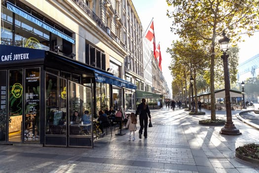 Central street of Paris The Avenue des Champs-Elysees with luxury shops and street life. Paris, France - November 24, 2024