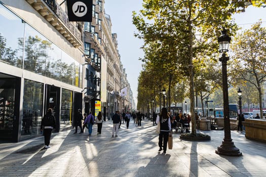 Central street of Paris The Avenue des Champs-Elysees with luxury shops and street life. Paris, France - November 24, 2024