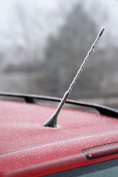 Frozen roof with antenna on car. Concept for winter time and transportation