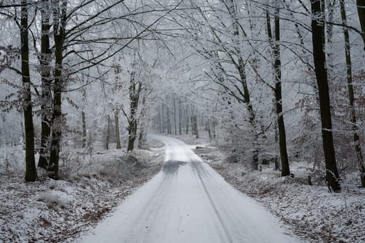 Snowy winter road with car. Dangerous car driving in the mountains in the winter. Concept for transportation, cars and travel.