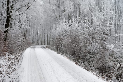 Snowy winter road with car. Dangerous car driving in the mountains in the winter. Concept for transportation, cars and travel.