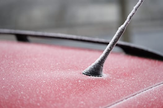Frozen roof with antenna on car. Concept for winter time and transportation