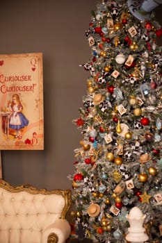 A decorated Christmas tree, a white leather sofa and a poster on the wall with fairy tales. Christmas magic. interior.