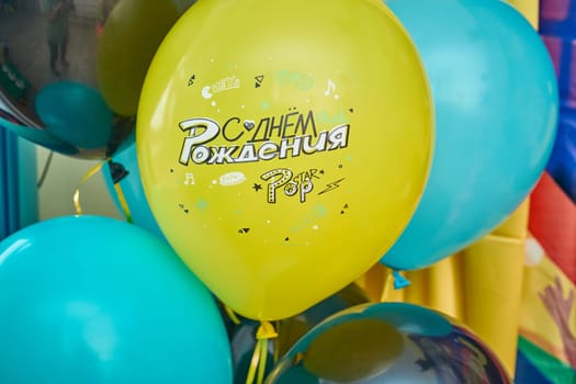 festive birthday party or holidays background with balloons close up. blue balloons isolated on blue background with copy space for text. background for birthday greeting card