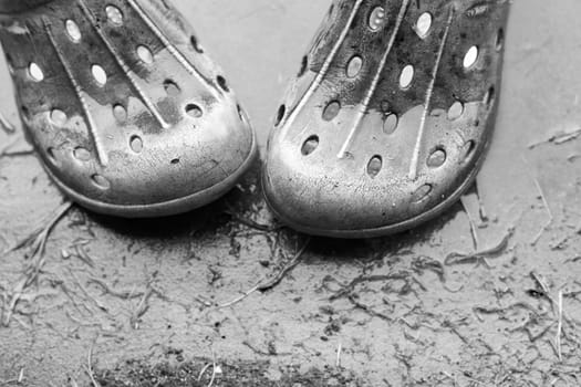 flip-flops for cottages dirty from the weather on the background of a concrete path