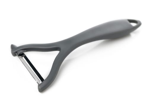A simple yet elegant vegetable peeler awaits its next task, showcasing minimalist design and ready for kitchen tasks.