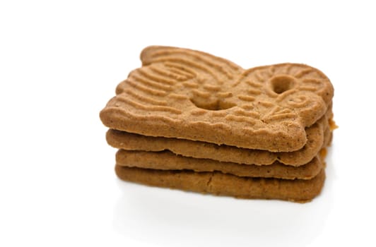 Unique gingerbread cookies stack on a clean white background, inviting you to enjoy their deliciousness.