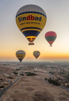 Luxor, Egypt - 31 October 2024: Many hot-air balloons over Sahara desert and Valley of Kings near Luxor, Egpyt