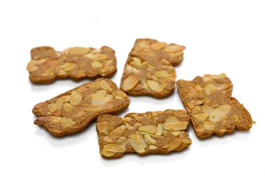 Savor the unique textures of gingerbread cookies adorned with crunchy almond slices, perfect for any occasion.