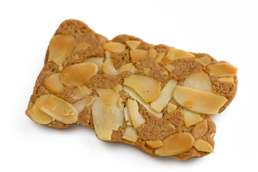 A delightful cookie crafted with almond pieces and a whimsical shape rests on a clean white background, inviting taste.