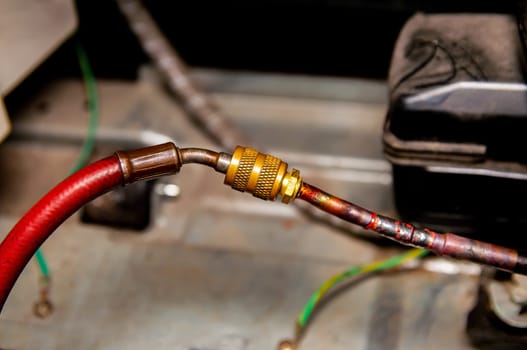 Tools for filling refrigerators and air conditioners. Working hand tools. Service of air conditioners and refrigerators. Pliers, pressure gauge and multimeter. Working industrial equipment.