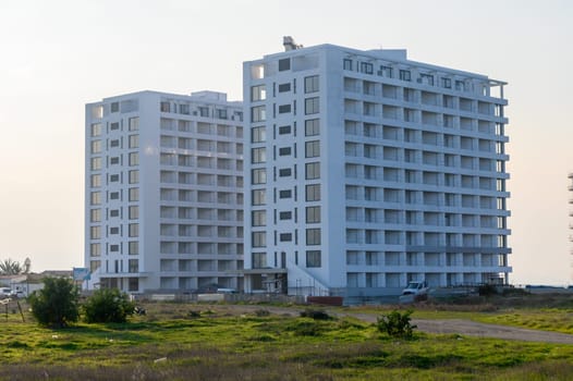 Two contemporary apartment towers stand tall amidst a serene landscape, reflecting modern urban living.