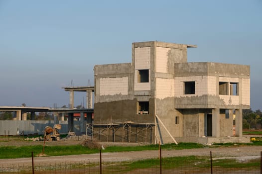 Progress of a contemporary building rises amid the open fields, marking a new chapter in rural development.