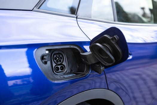 Fast charging socket type 2 combo electric car. Type 2 CCS plug port on electric vehicle. DC - CCS type 2 EV charging connector at EV car. Eco friendly alternative energy green environment concept