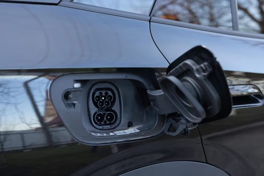 Fast charging socket type 2 combo electric car. Type 2 CCS plug port on electric vehicle. DC - CCS type 2 EV charging connector at EV car. Eco friendly alternative energy green environment concept