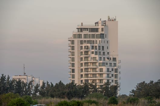 Skyline silhouette reveals a contemporary building as twilight paints the backdrop in soft hues of dusk.