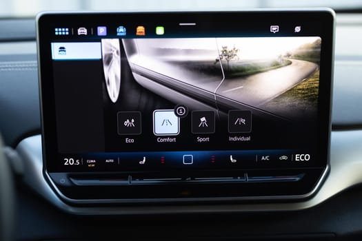 Driving mode button on luxury electric car. Eco mode is a relaxed and comfort sport is a fuel efficient driving mode. Smart electric vehicle concept. Sport Mode button of a car. Pressing the button.