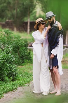 full length view of fashionable couple looking at camera outdoor.