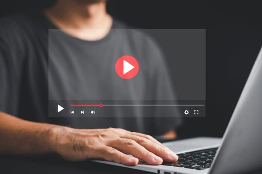 Man watching a live stream on the internet. Conceptual image of online video streaming with a multimedia player on the screen. Stay entertained and informed with digital media.