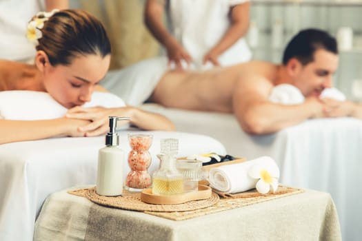 Aromatherapy massage on daylight ambiance or spa salon composition setup with focus decor and spa accessories on blur woman enjoying blissful aroma spa massage in resort or hotel background. Quiescent