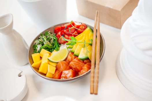 Poke bowl with salmon on white background. Top view. High quality photo