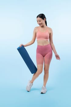 Young attractive asian woman portrait in sportswear with exercising mat. Healthy exercise and workout routine lifestyle concept. Studio shot isolated background. Vigorous