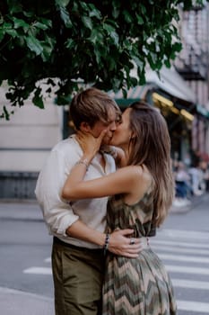A couple lovingly shares a tender embrace in front of lush vibrant greenery, capturing intimate moments of deep love