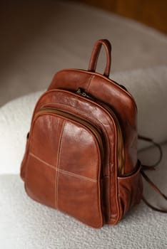 photo of a brown leather backpack with retro look. indoors photo