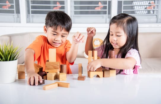 Children boy and girl playing with constructor wooden block building, Happy little kids play wood block stacking board game at home, activities learning creative, toys for preschool and kindergarten