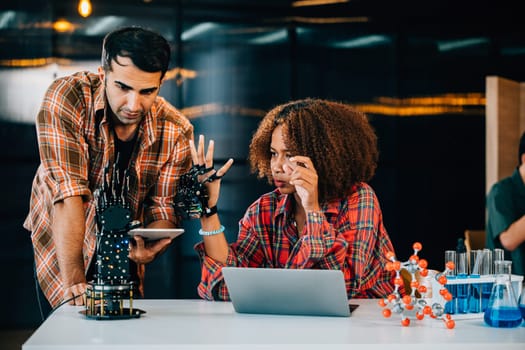 In a classroom a teacher mentors a student crafting a robotic arm for design and technology lessons. Nurturing innovation discovery and coding skills with enthusiasm. Robot hand. technology concept