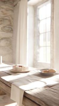 Sunlit rustic kitchen interior with bread and cheese on wooden table.