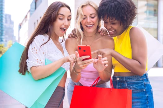 A group of three joyful women cheering and celebrating while looking at a smartphone. A vibrant and fun moment showcasing friendship, happiness, and modern connections.