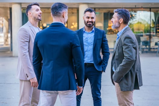 A group of business professionals engaged in a serious discussion outdoors. They are dressed in formal and smart casual attire, with a modern cityscape in the background.