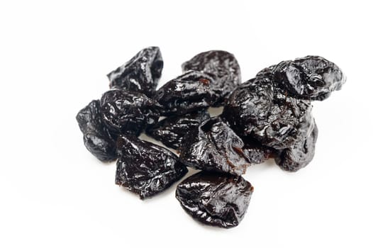Juicy dried fruits are beautifully arranged, showcasing their rich textures and deep colors against a white backdrop.