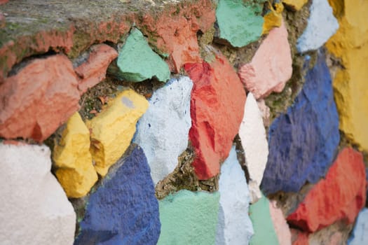 A stunningly vibrant mosaic wall adorned with a variety of colorful stones and unique textures