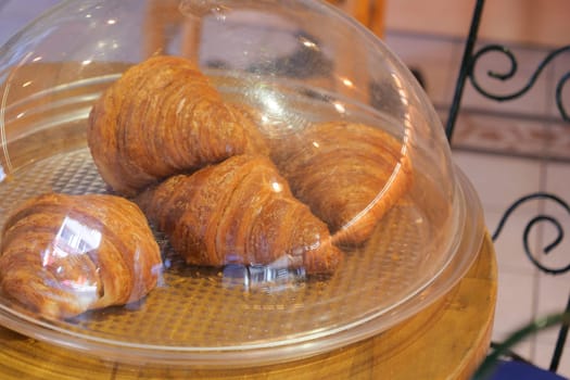 fresh baked croissant in a bakery .