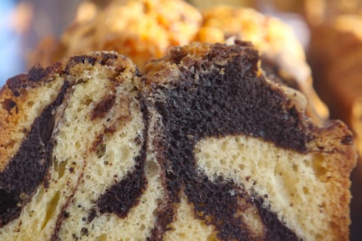 A closeup of rich chocolate marble cake showcasing enticing swirls and intricate design