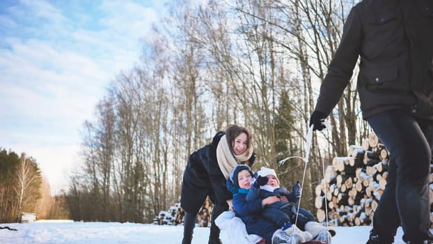Family enjoying a joyful winter day, sledding down a snowy hill, creating lasting memories together in a beautiful, wintry landscape