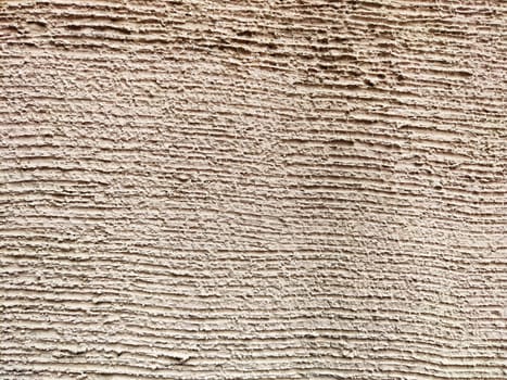A rustic textured wall showcases intricate patterns and lines, providing an ideal backdrop for text or design elements in various formats.