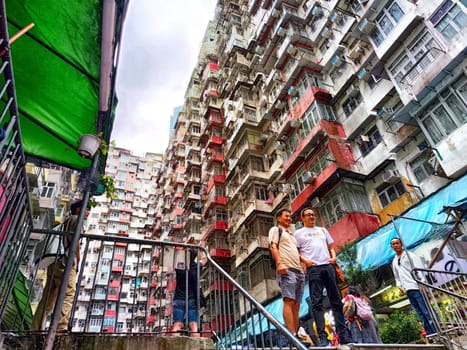 Hong Kong, China - April 06, 2024 - Tourists gather around the famous monster apartment building in Hong Kong, immersed in the dynamic atmosphere of the city. The monster House.