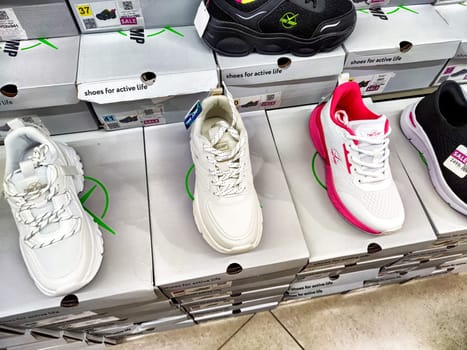 Kirov, Russia - August 01, 2024 - A variety of shoes in different styles and colors are neatly arranged on shelves in a store promoting active life.
