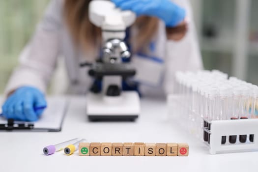 In a laboratory setting, scientists carefully analyze cortisol levels using advanced microscopes and test tubes