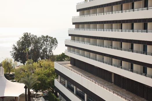 This modern hotel has lovely balconies, lush greenery, and stunning ocean views, ideal for relaxation