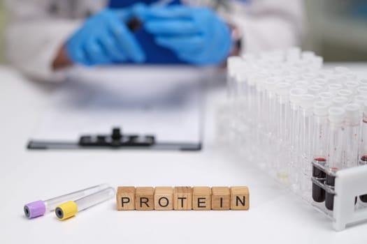 This is a closeup view of protein analysis taking place in a laboratory featuring test tubes and medical tools