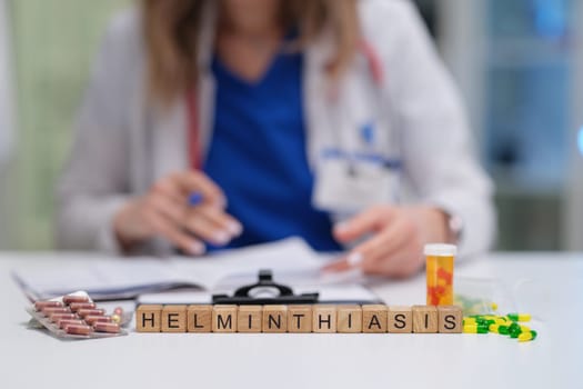 A medical professional is carefully reviewing various treatment options and medications available for helminthiasis