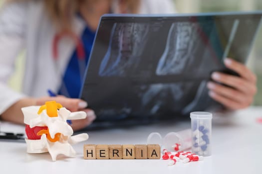 A dedicated healthcare professional is thoroughly analyzing hernia Xray images with various models and medications