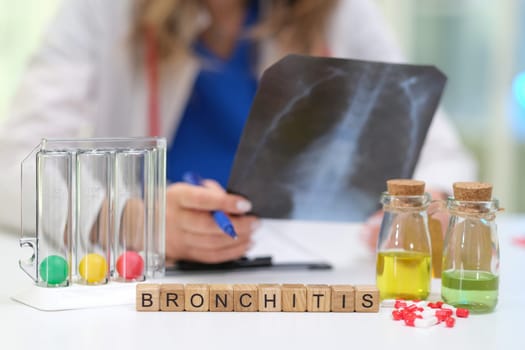 A doctor is comprehensively analyzing a case of bronchitis using an Xray and test samples in a clinical environment