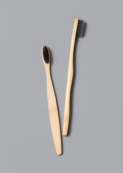 Two biodegradable bamboo toothbrushes on a light gray background top view, copy space. Zero waste and no plastic concept.
Natural personal accessories for tooth care, minimal style aesthetic flatlay