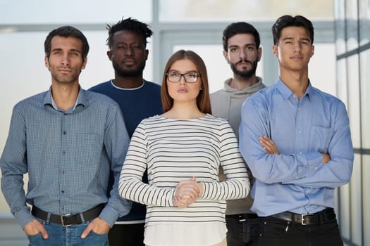 Diverse business people stand in the lobby of a modern office.